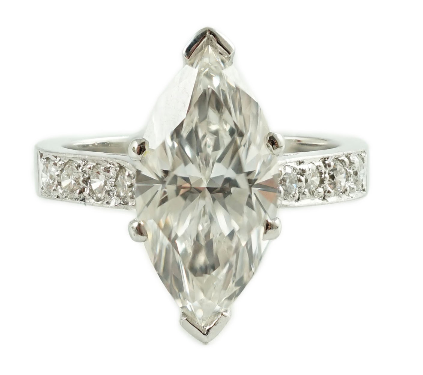A modern 18ct white gold and single stone marquise diamond set dress ring, with graduated diamond set shoulders, with accompanying WGI report dated 18/6/2021, stating the stone to weigh 3.70ct
